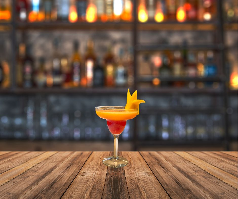 Frozen Mango Breeze Mocktail served in a glass with pineapple garnish